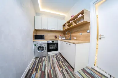 a small kitchen with a washing machine in it at Sofia Colour Life Apartment -No Window Apartment in Sofia