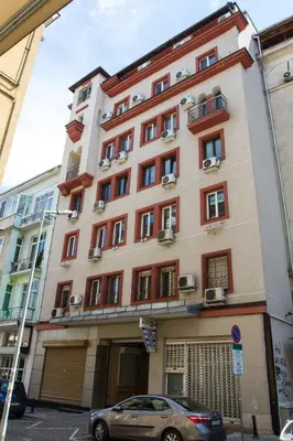 a building with a car parked in front of it at Sofia Colour Life Apartment -No Window Apartment in Sofia