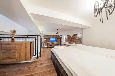 a bedroom with a large bed and a tv at Sofia Parter Life Apartment in Sofia