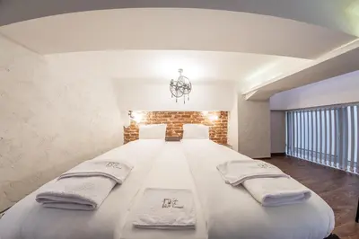 a bedroom with a large bed with towels on it at Sofia Parter Life Apartment in Sofia