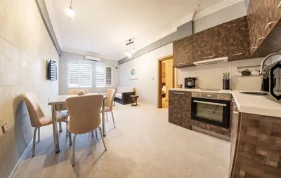 a kitchen and dining room with a table and chairs at Sofia Industrial Life Apartment in Sofia