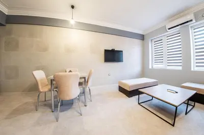 a room with a table and chairs and a tv at Sofia Industrial Life Apartment in Sofia