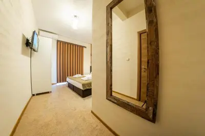 a mirror on a wall in a room at Sofia Industrial Life Apartment in Sofia