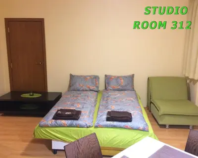 a bedroom with a bed with two bags on it at Villa Park Studio&Double room in Borovets