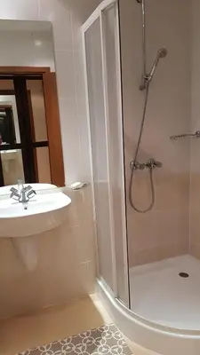 a bathroom with a sink and a shower at Villa Park Studio&Double room in Borovets