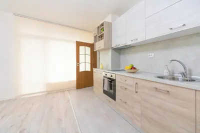 a kitchen with white cabinets and a sink at Domus Apartments Grand with Parking in Plovdiv