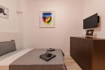 a bedroom with a bed and a flat screen tv at CACAO Studio next to Crystal Garden and Russian Church by Flat Mаnager in Sofia