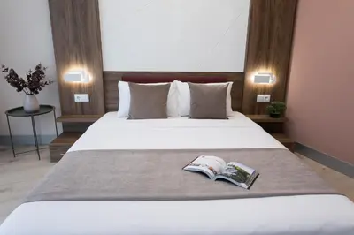 a hotel room with a bed with a book on it at B1 Boutique Hotel Sofia in Sofia