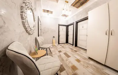 a living room with a table and chairs and a mirror at Sofia Downtown Life Apartment in Sofia