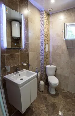 a bathroom with a white sink and a toilet at Apartment Petya in Velingrad