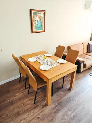 a dining room table with chairs and a couch at Apartment Petya in Velingrad