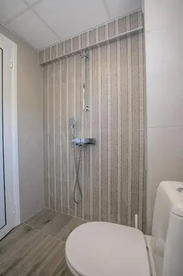 a bathroom with a shower with a toilet in it at Sunpark Apartment in Sandanski