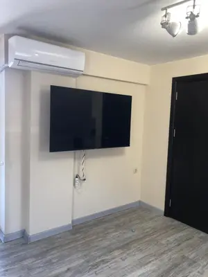 a flat screen tv hanging on a wall at Sunpark Apartment in Sandanski