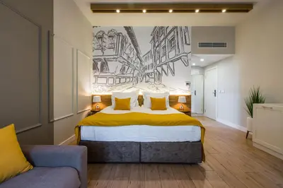 a bedroom with a bed and a couch at HillHouse Plovdiv in Plovdiv