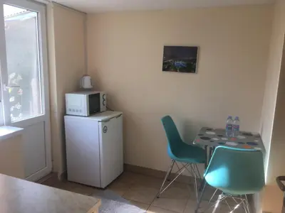 a small kitchen with a table and a microwave at Нощувки Пловдив Тепето Plovdiv Hill in Plovdiv