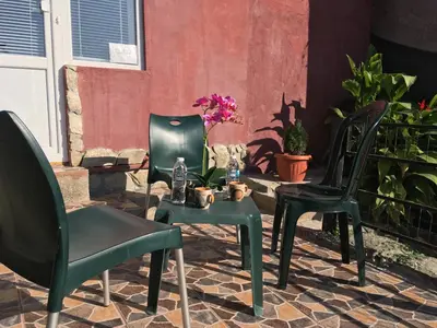 two chairs and a table on a patio at Нощувки Пловдив Тепето Plovdiv Hill in Plovdiv