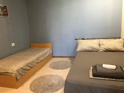 a bedroom with two beds and two rugs at Нощувки Пловдив Тепето Plovdiv Hill in Plovdiv