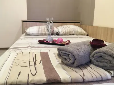 a bed with towels and flowers on top of it at Нощувки Пловдив Тепето Plovdiv Hill in Plovdiv