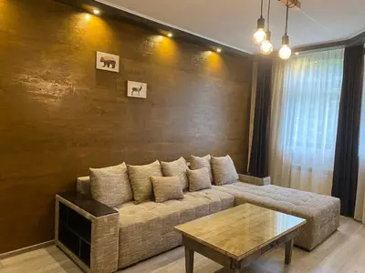 a living room with a couch and a table at Deluxe 217 in Borovets
