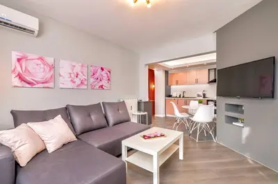 a living room with a couch and a table at ROSÉ one bedroom designer apartment in city centre by Flat Mаnager in Sofia