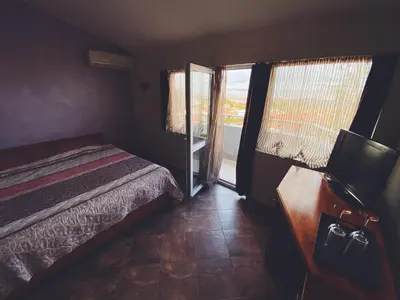 a small bedroom with a bed and a window at Hotel Fancy in Sofia