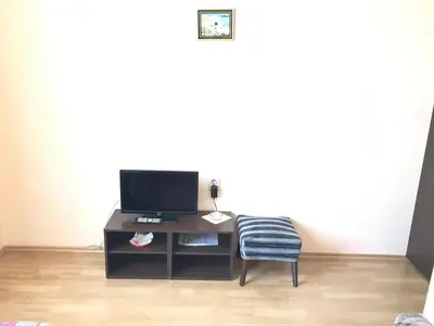a room with a desk with a tv and a chair at МОТЕЛ СИТИ с БЕЗПЛАТЕН ПАРКИНГ in Plovdiv