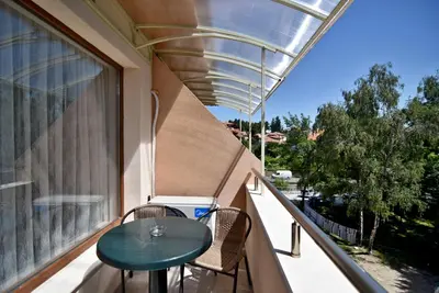 a balcony with a table and chairs and a window at City Apartments in Velingrad