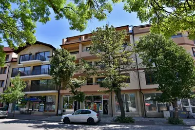 a white car parked in front of a building at City Apartments in Velingrad