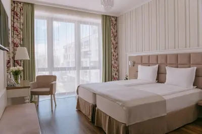 a bedroom with a large bed and a large window at Impresamente Art Hotel in Sofia