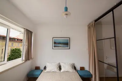 a bedroom with a bed with two pillows and a window at Design Apartment in Sofia top city center in Sofia