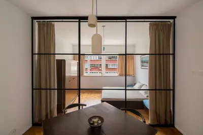 a room with a dining table and a living room at Design Apartment in Sofia top city center in Sofia