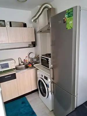 a kitchen with a refrigerator and a washing machine at encanto in Plovdiv