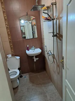 a bathroom with a toilet and a sink and a shower at encanto in Plovdiv