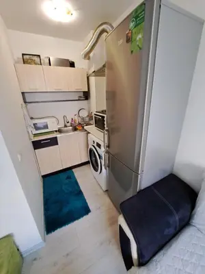 a small kitchen with a refrigerator and a sink at encanto in Plovdiv