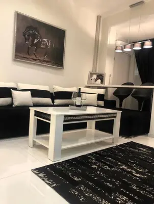 a living room with a couch and a table at Zero-Waste Studio Apartment in Central Sofia in Sofia