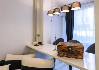 a room with a table with a basket and chairs at Zero-Waste Studio Apartment in Central Sofia in Sofia