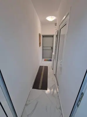 a hallway with white walls and a stairway at lux in Plovdiv