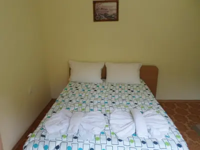 a bedroom with a bed with towels on it at Семеен Хотел 