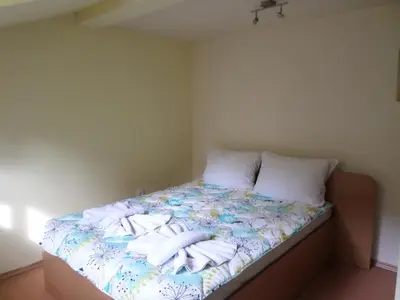 a bedroom with a bed with towels on it at Семеен Хотел 