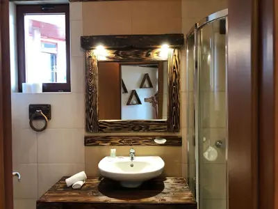 a bathroom with a sink and a mirror and a shower at Pamporovo Villa in Pamporovo