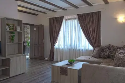 a living room with a couch and a large window at СТАР МЕРАК in Ribarica