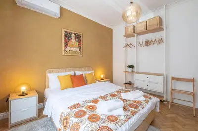 a bedroom with a large bed with pillows on it at Sophisticated Gem with Private parking in Sofia