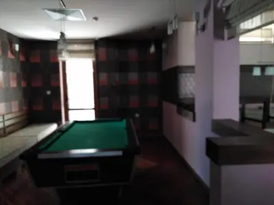 a room with a green pool table in it at Ски апартамент, студио Хрис, Лъки Пампорово in Pamporovo