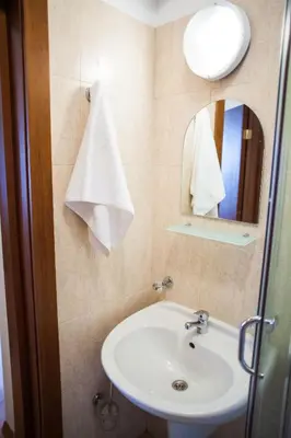 a bathroom with a sink and a mirror at Two bedroom apartments in Murphys Lodge in Bansko