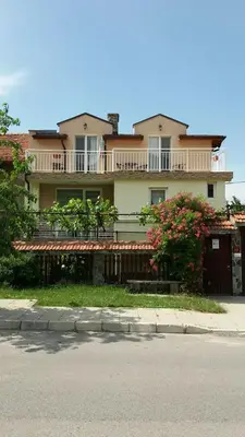 a large house with a balcony on the side of the street at Къща за гости DANI DREAM in Sapareva Banya