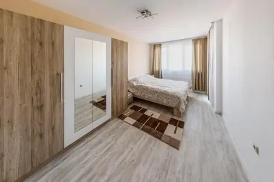 a bedroom with a bed and a mirror at NEXT TO GONDOLA Stylish and Charming apartment in Bansko