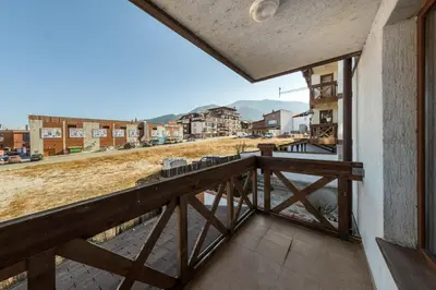 a balcony with a view of a city at NEXT TO GONDOLA Stylish and Charming apartment in Bansko