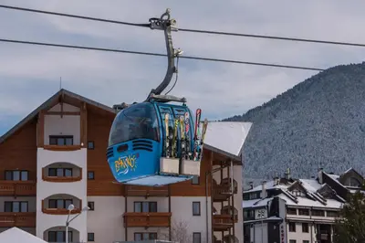 a ski lift in front of a building at NEXT TO GONDOLA Stylish and Charming apartment in Bansko