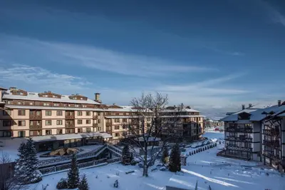 a large building with snow on the ground at NEXT TO GONDOLA Stylish and Charming apartment in Bansko