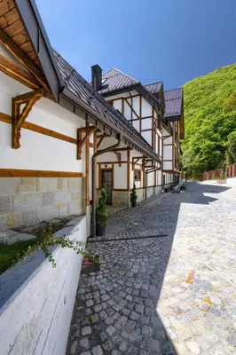 a building with a stone walkway in front of it at Hotel Apostolite in Sandanski